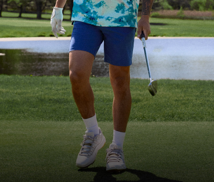 Person playing golf on a green course